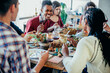 © JEFF WASSERMAN/Stocksy - Laughing at Thanksgiving Dinner Party