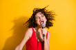 © deagreez - Closeup portrait photo of cute crazy young girl hand hold mic open mouth eyes closed sing funky hipster song wear red singlet unclothed shoulders isolated vibrant yellow color background