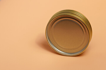 Metal caps for canning in the rib position on an orange background close-up