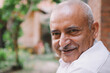 © SHIKHAR BHATTARAI/Stocksy - Smiling old man of South Asian descent.