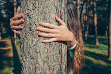 Redhead Girl Hugging A Tree