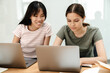 © Drobot Dean - Photo of happy multinational students girls doing homework with laptops
