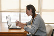 © BONNINSTUDIO/Stocksy - Young woman studying with laptop in a room.