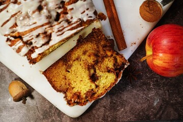 Poster - Homemade Apple Fritter Bread drizzled with white glaze on fall autumn background, selective focus