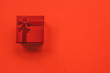 © Wizemark/Stocksy - Single red Christmas box/gift on a vibrant red background