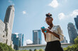 © simon/Stocksy - Black businesswoman using a phone in New York City