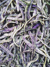 Pile Of Organic Purple Bush Beans For Sale At Farmer's Market