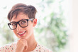 © Tetra Images - Portrait of smiling woman wearing eyeglasses