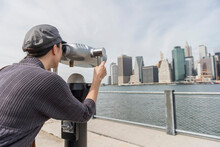 Woman Watching Cityscape Through Coin-operated Binoculars