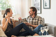 © Tetra Images - Cheerful couple eating on sofa