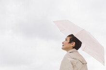 Woman Wearing Raincoat And Holding Umbrella