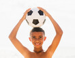 © Tetra Images - Boy (10-11) holding soccer ball on head