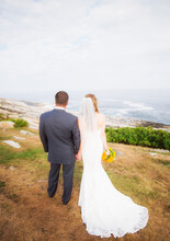 Rear View Of Married Couple Standing By Sea