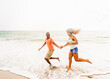 © Tetra Images - Young couple running on beach