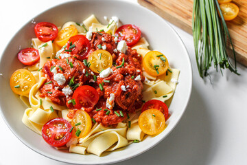 Poster - Meatball pasta with cherry tomatoes. Fresh beautiful pasta dish. White background. 