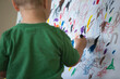 © Noah Clayton/Tetra Images - Toddler drawing on wall