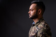 © Ranta Images - Young bearded Indian man against gray background
