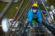 © JELENA JOJIC TOMIC/Stocksy - Working at heights, technician climbs up on a communications tower