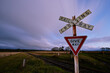 © Joaquim Bel/Stocksy - Railway Crossing Sign