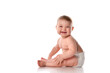 Smiling baby sitting on floor over white copyspace