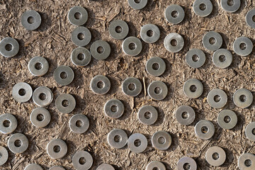 Stainless shims on wooden background