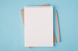 © ActionGP - Top above overhead view flat lay  photo of a blank notebook and a pencil beside isolated on pastel blue color background with copyspace