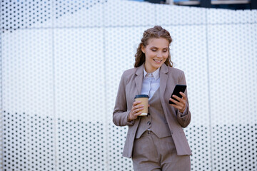 young businesswoman in glasses is messaging on the smartphone