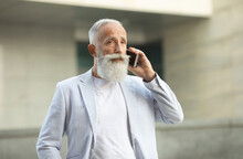 Excited Old Man In Jacket With White Hair And Beard Talking On Phone.