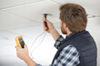 © auremar - electrician using a multimeter to test spotlight connections