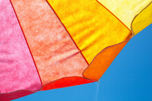 Colorful Abstract Of A Beach Umbrella Against A Blue Sky