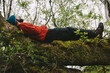 © Andy Campbell/Stocksy - A hiker relaxes on a fallen tree