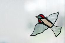 Stained Glass Bird Decoration On A Window