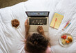 © Mosuno/Stocksy - Woman Using Laptop in a Hotel Room