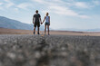 © simon/Stocksy - Couple holding hands on the road