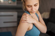 © brillianata - Women wearing athletic suits feeling shoulder pain after exercise at home. The danger of self-training