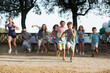 © MIQUEL LLONCH/Stocksy - Group of children running at an outdoors party