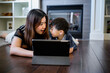 © Take A Pix Media/Stocksy - Asian boy watching on his tablet with his mother at home