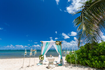 Sticker - Wedding bamboo gazebo, decorated with tropical flowers and coloured fabrics on the paradise beach with palm trees, white sand and blue water of Caribbean Sea, Punta Cana, Dominican Republic 