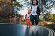 © Rob and Julia Campbell/Stocksy - Cute girl in fox and boy in raccoon costume jumping on trampoline