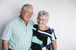 © Rob and Julia Campbell/Stocksy - Senior couple enjoying each other in front of white background