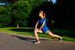© Mosuno/Stocksy - Woman Stretching Before Jogging in the Park