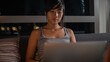 © Audrey Shtecinjo/Stocksy - Close up/detail of beautiful asian woman using her laptop in her home during evening.
