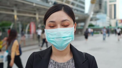 Wall Mural - business woman wearing medical mask for protection from coronavirus (covid-19) pandemic in the city