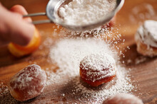 Pouring Icing Sugar On Donut Holes