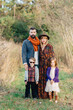 © Jakob Lagerstedt/Stocksy - Beautiful and trendy family standing by a field