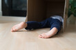 © Tara Romasanta Photography/Stocksy - child resting face down inside a box