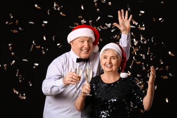 Sticker - Elderly couple with champagne celebrating Christmas on dark background