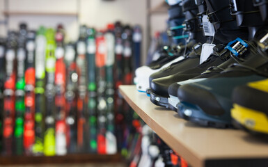 Sport equipment shop interior with large assortment of modern ski boots