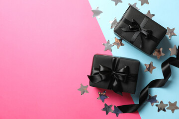 Gift boxes with black bow on two tone background