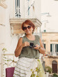 © katrinshine - Woman drinking coffee on a balcony in Italy